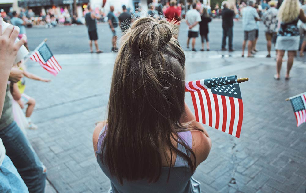 child holding American flag at parade