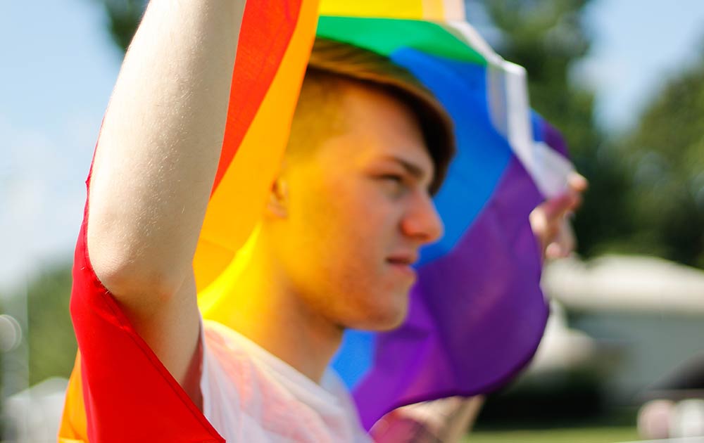 person holding pride flag