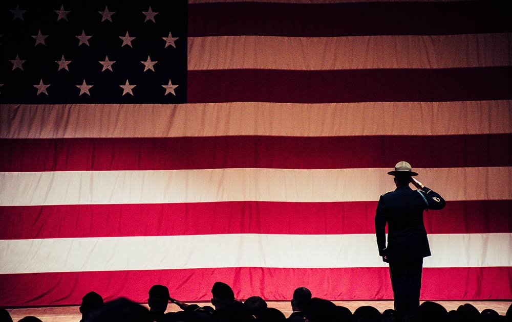 Soldiers saluting American flag