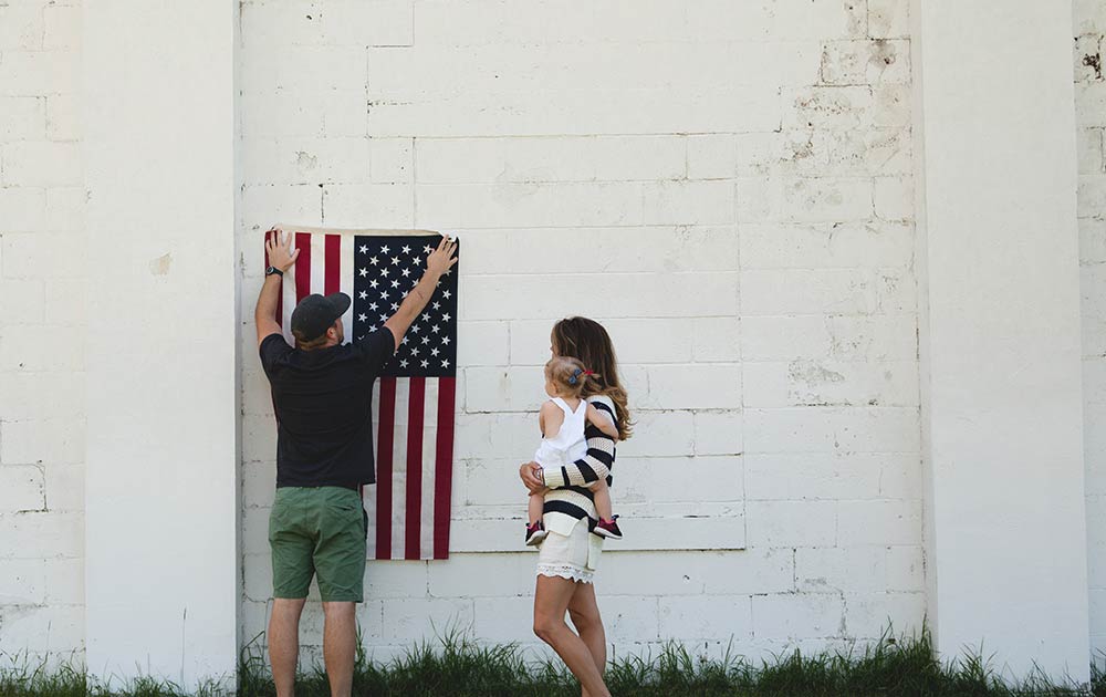 family hanging American flag