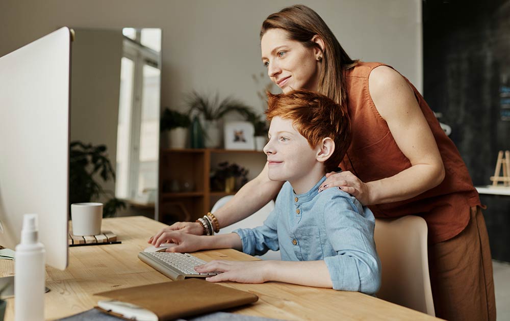 mom and son using computer
