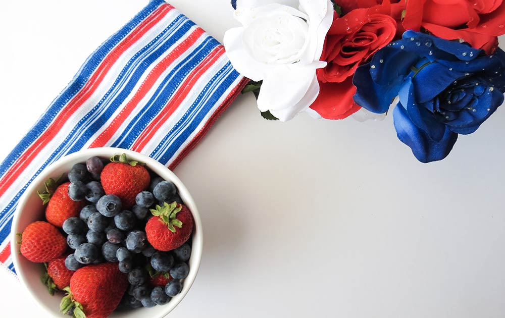 patriotic table spread with berries and set pieces 